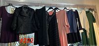 Row of nine hanging garments showing overall lot