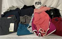 Pile of assorted clothing showing variety of colors and visible new-with-tag item
