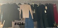 Overall shot of eight garments hung on rack
