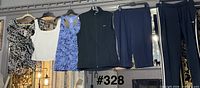 Five garments on hangers showing overall styles and colors