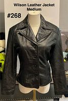 Front view of black Wilsons Leather jacket on mannequin