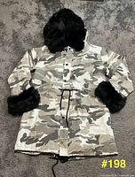 Front view of camo coat with hood and faux fur trim