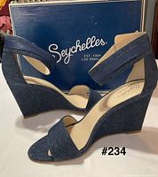 Profile view of both sandals against branded box
