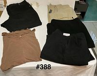 Group of five garments folded on table
