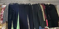Row of hanging tops, pants and sweatshirt dress