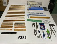 Full lot overview showing rulers, drafting tools, calculator, paper trimmer