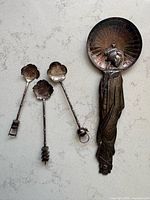 Full view of spoon rest with three spoons showing scale and design