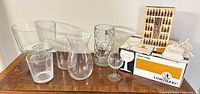 Overall shot of all glass pieces, whiskey stones bag, book and Luminarc box on table