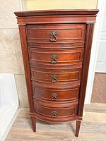 Front view showing full height, five drawers, hardware, legs
