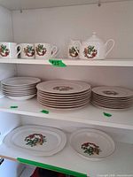 Full set on shelving showing plates, bowls, serving pieces