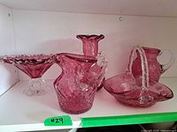 Shelf view of all five cranberry glass pieces