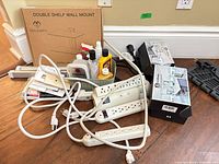 Group shot showing boxed shelf mount, power strips, cabinet hardware boxes, LED light bars, bulbs, screws