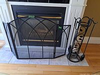 fireplace screen and tool stand in front of fireplace