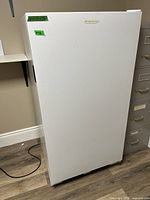 Full view of white upright freezer front
