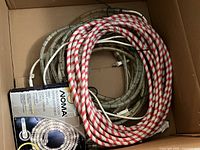 Coiled red-white and clear rope lights with connectors and NOMA box in carton