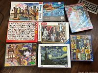 Group shot of all eight boxed puzzles laid out