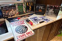 All items laid out: books, sign, pizza cutter, magazines