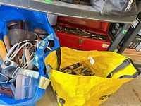 Reusable tote bags and red toolbox filled with hand tools and hardware