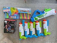 Group view of all water toys and lawn darts box