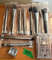 Front view of all Quo brushes, Guerlain set, and sharpener