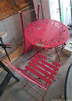 Full view of table and one chair with folded chair behind