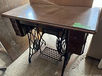 Full view of wood-top table on Singer cast iron base with drawers