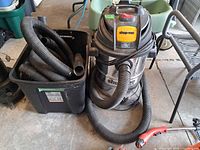 Shop-Vac canister vacuum with hose and accessories in tote