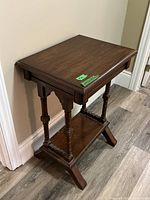 Full view of table showing overall design, turned legs, lower shelf