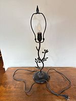Full view of lamp showing base, branch design, socket, harp, cord