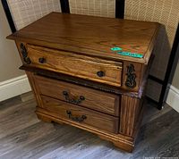 Front angled view of nightstand showing all three drawers and hardware