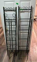 Front view of both metal racks showing shelves and scrollwork