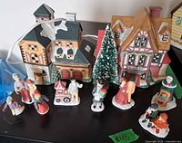 Group shot of both ceramic houses, bottle brush tree, and nine figurines