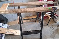 Overall view of folding metal workbench with wooden jaws and vise handles