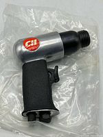 Left side view of Campbell Hausfeld air hammer showing logo and grip