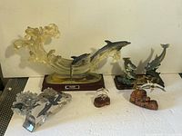 Group view of all five dolphin figurines on tabletop