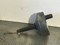 Side view of drum drain auger showing handle, drum housing and cable tip