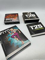 All four Beachbody DVD sets laid out
