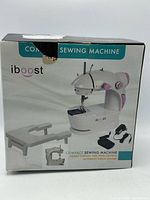 Front of boxed iBoost compact sewing machine