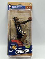 Front view of sealed Paul George figure in packaging