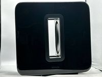 Front view of Sonos Sub showing glossy finish and central slot