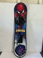 Top view of Spider-Man kids snowboard showing graphics and binding