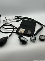 Overall view of sphygmomanometer components and two stethoscopes