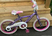 Full left side view showing frame, tires, chainguard, pedals