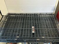 Top view of folded black wire crate showing overall structure