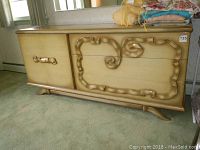 Dresser front view showing three large drawers on right, two doors on left with carved scrollwork design and matching sculptural handles, light wood finish