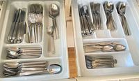 Two flatware drawer trays showing both sets sorted by utensil type