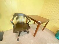 Front view of Bexnins swivel chair beside rectangular side table