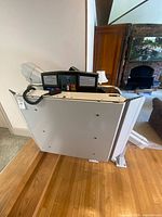 Folded Garaventa X3-R platform lift installed on staircase; control panel visible