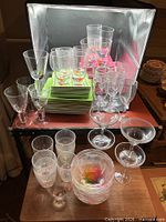 Plates stacked with assorted glasses and bowls