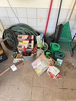 Overview of hoses, boxed edging, tools and watering cans